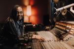 image of Ebonie Smith sitting at a mixer console.